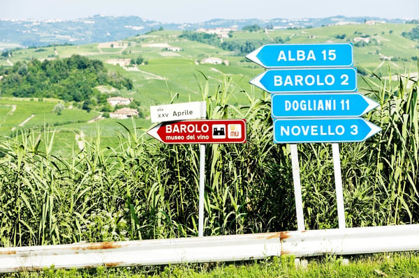 Road signs in Piedmont showing directions to Alba, Barolo and Novello