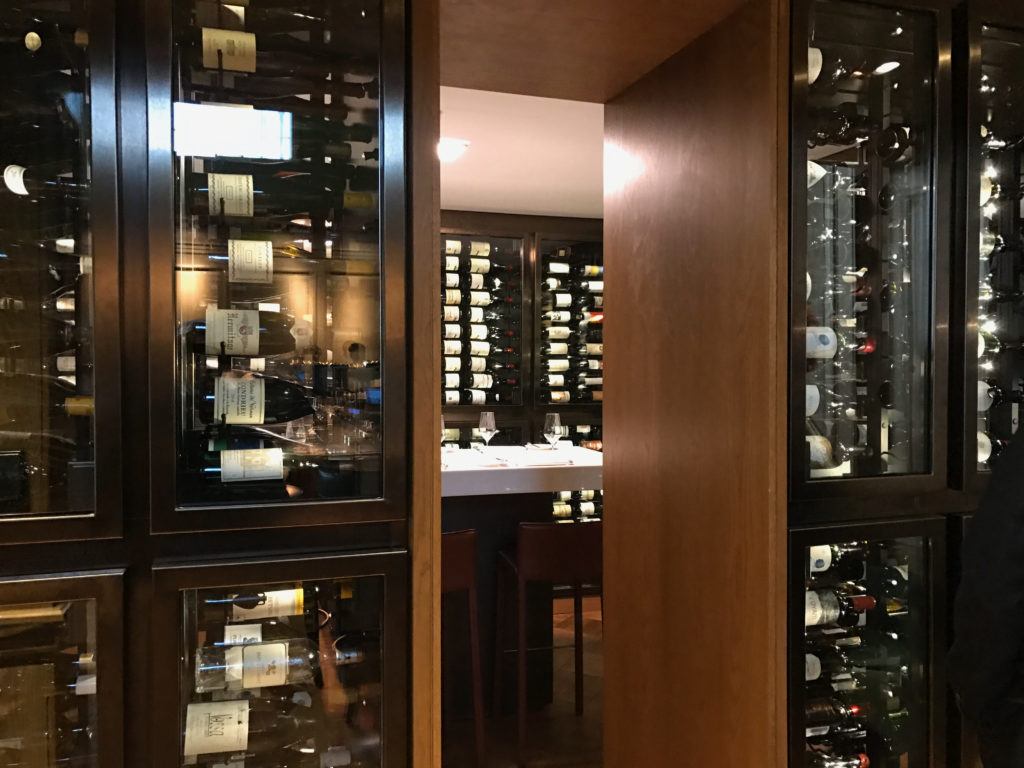 A dining room surrounded by wine fridges at 67 Pall Mall