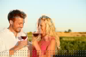 man and a woman outdoors drinking the best red wine