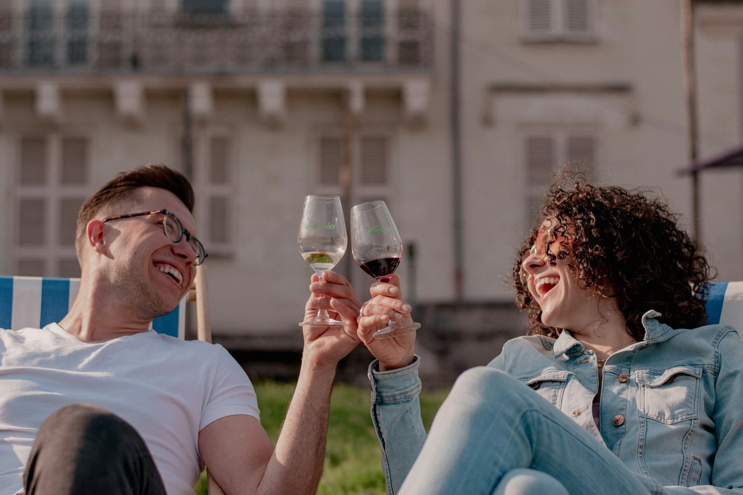 Two people drinking wine and laughing