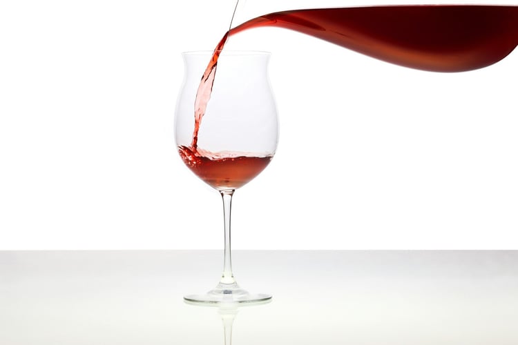 Red wine being poured from a decanter